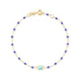 Load image into Gallery viewer, 18k yellow gold cable chain bracelet with blueuet colored resin beads and a single evil eye resin charm stationed to the middle of the chain by Gigi Clozeau.