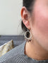 Load image into Gallery viewer, Model wearing handmade sterling silver earrings by Philippa Roberts featuring round and rectangular tourmalines in soft pink and green shades, made in Oakland, CA.
