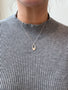 Load image into Gallery viewer, Model wearing handmade sterling silver necklace by Philippa Roberts featuring a delicate open oval pendant for a simple, chic look, made in Oakland, CA.
