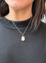 Load image into Gallery viewer, Model wearing handmade sterling silver necklace by Philippa Roberts featuring a pink opal pendant accented with silver nuggets, hanging approximately 1 1/8 inches from a 16-inch starburst chain with a 2-inch extender.
