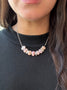 Load image into Gallery viewer, Model wearing sterling silver statement necklace with three organic nugget forms and pink opal stones, handmade designer jewelry by Philippa Roberts.
