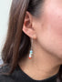 Load image into Gallery viewer, Model wearing modern silver earrings with layered opals and sculptural design by Philippa Roberts.
