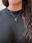 Load image into Gallery viewer, Model wearing handmade turquoise, lapis, and blue topaz cluster necklace in silver by Philippa Roberts on a fine cable chain with extender.
