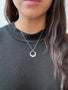 Load image into Gallery viewer, Model wearing handmade sterling silver circle necklace with minimalist modern pendant by Philippa Roberts.
