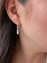 Load image into Gallery viewer, Model wearing Philippa Roberts tiny sterling silver drop earrings with delicate handmade drops, crafted in Oakland, California.
