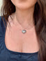 Load image into Gallery viewer, Model wearing Anzie sterling silver heart locket necklace with star design and white sapphire center stone, timeless keepsake pendant jewelry.
