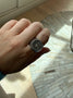 Load image into Gallery viewer, Model wearing sterling silver signet ring by Digby &amp; Iona featuring the engraved Latin inscription "Omnes Qui Errant Non Pereunt" around the band.

