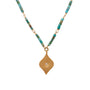 Load image into Gallery viewer, Necklace with turquoise beads and a gold pendant with a diamond by Ananda Khalsa

