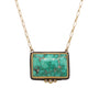 Load image into Gallery viewer, Rectangle cabachon turquoise pendant bezel set in 22k yellow gold with a trio of white diamond accents at the bottom and a sterling silver back hanging from a 14k yellow gold paperclip chain by Ananda Khalsa. 
