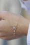 Load image into Gallery viewer, Close up of 14k light yellow gold Dream Maker phoenix necklace featuring a pear-shaped moonstone, diamond accents, and a small dangling diamond in an openwork, celestial-inspired design.
