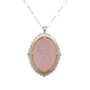 Load image into Gallery viewer, A mixed metal necklace made from a rim of sterling silver flush set with champagne and white diamond accents surrounding a carved rose quartz cabachon prongset in 18k yellow gold on a sterling silver chain, by Adel Chefridi. 
