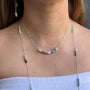 Load image into Gallery viewer, Model wearing stacked opal necklace with a vertical 2-inch arrangement of luminous opals set in sterling silver suspended from a 16-inch bar chain with a 2-inch extender.

