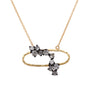 Load image into Gallery viewer, 18k yellow gold open oval necklace with a scattering of inverted white diamonds prong set in oxidized 14k white gold.
