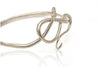 Load image into Gallery viewer, Side view of sterling silver serpent bangle with diamond eye. 
