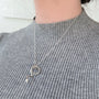 Load image into Gallery viewer, Model wearing sterling silver serpent necklace by Annette Ferdinandsen with a pearl drop hanging from the serpent’s mouth.
