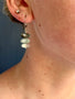 Load image into Gallery viewer, Close-up of an earring with layered stones against a blue background
