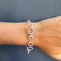 Load image into Gallery viewer, Model wearing sterling silver rings bracelet with interlocking links handmade by Philippa Roberts.
