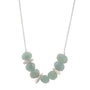 Load image into Gallery viewer, Sterling silver statement necklace with three organic nugget forms and aquamarine stones, handmade designer jewelry by Philippa Roberts.
