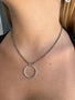 Load image into Gallery viewer, Silver and pyrite necklace with a circular pendant on a person's neck.
