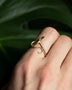 Load image into Gallery viewer, Model wearing 14k yellow gold serpent ring with white diamond head and diamond eyes.
