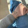 Load image into Gallery viewer, Model wearing Sterling silver serpent bangle by Annette Ferdinandsen with white diamond eyes, symbolizing transformation and rebirth.
