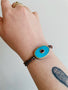 Load image into Gallery viewer, Turquoise and Ruby Eye Bracelet + Red Blue Multi Braided Cord
